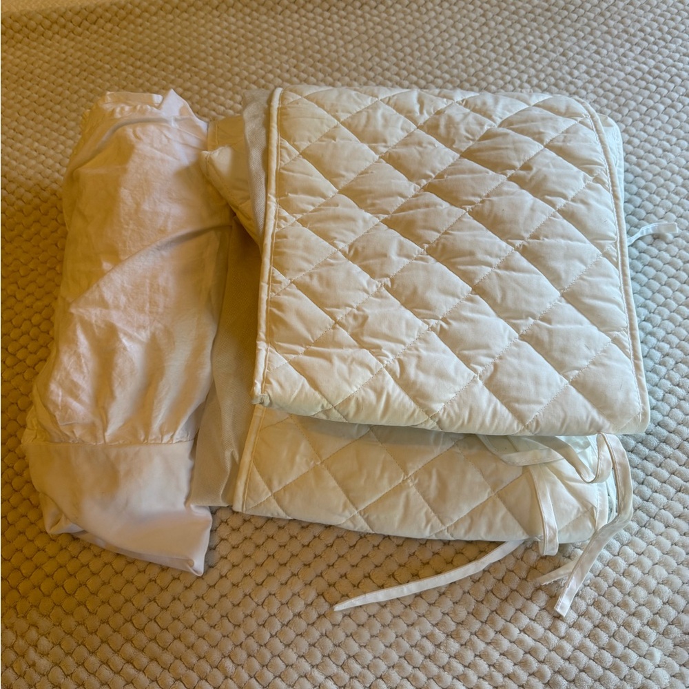 White Cotton crib bumper with white ruffled bedskirt